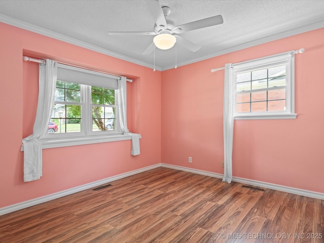 927 Macklyn Ln, Bartlesville, OK 74006 - unfurnished room with wood finished floors, a textured ceiling, a ceiling fan, and crown molding