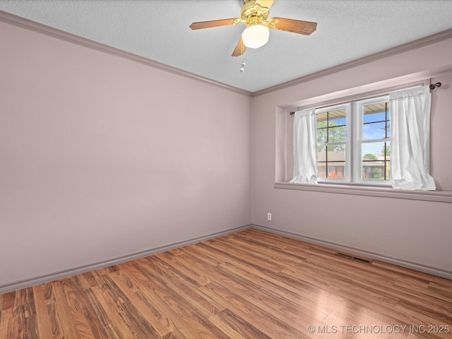 927 Macklyn Ln, Bartlesville, OK 74006 - unfurnished room with wood finished floors, crown molding, a textured ceiling, and ceiling fan