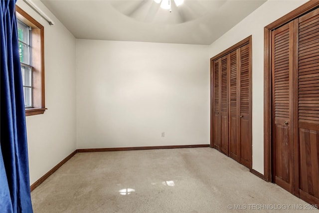 2900 S Cedar Ct, Broken Arrow, OK 74012 - unfurnished bedroom with two closets, light carpet, and a ceiling fan