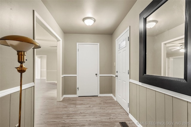 2900 S Cedar Ct, Broken Arrow, OK 74012 - hallway with light wood-style flooring and a wainscoted wall