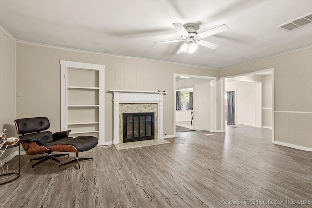 2900 S Cedar Ct, Broken Arrow, OK 74012 - living area with crown molding, wood finished floors, a high end fireplace, and ceiling fan