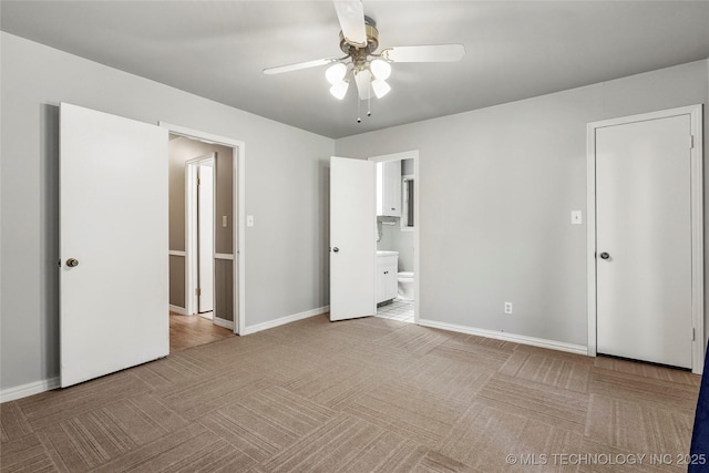 2900 S Cedar Ct, Broken Arrow, OK 74012 - unfurnished bedroom featuring carpet floors, connected bathroom, and a ceiling fan