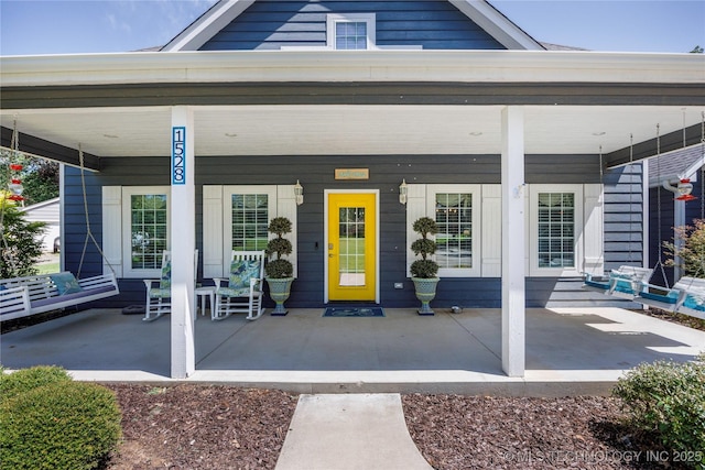 1528 Smysor Dr, Bartlesville, OK 74006 - view of exterior entry with a porch