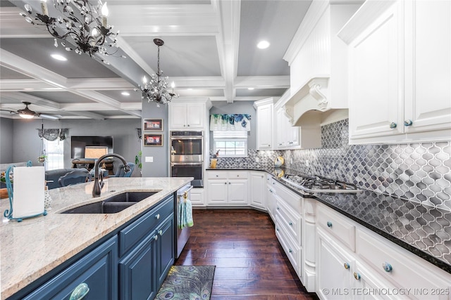 1528 Smysor Dr, Bartlesville, OK 74006 - kitchen featuring blue cabinets, appliances with stainless steel finishes, a chandelier, coffered ceiling, and white cabinetry