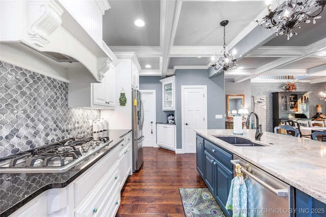 1528 Smysor Dr, Bartlesville, OK 74006 - kitchen with blue cabinetry, appliances with stainless steel finishes, premium range hood, a chandelier, and coffered ceiling