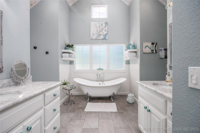 1528 Smysor Dr, Bartlesville, OK 74006 - bathroom with two vanities, a freestanding bath, wainscoting, and lofted ceiling