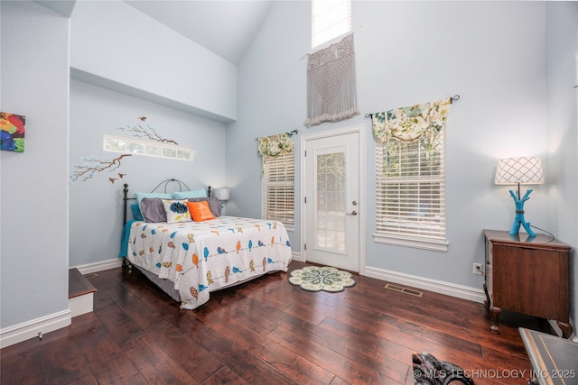 1528 Smysor Dr, Bartlesville, OK 74006 - bedroom with high vaulted ceiling, access to exterior, and wood-type flooring