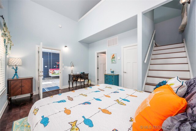 1528 Smysor Dr, Bartlesville, OK 74006 - bedroom featuring dark wood-type flooring and a towering ceiling