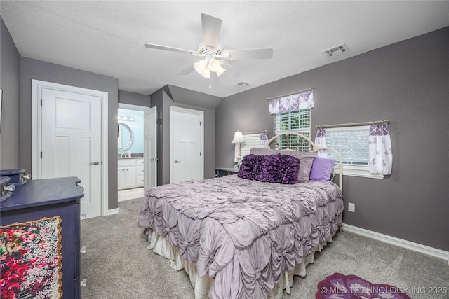 1528 Smysor Dr, Bartlesville, OK 74006 - carpeted bedroom with ensuite bath and ceiling fan