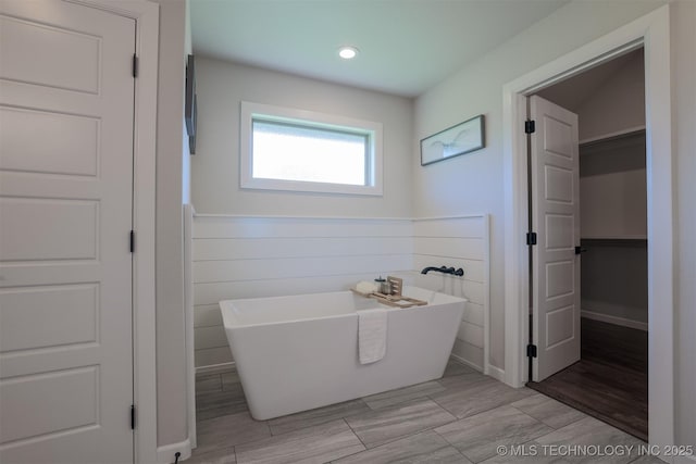 7141 E 138th Pl, Collinsville, OK 74021 - bathroom featuring a freestanding tub, a closet, and recessed lighting