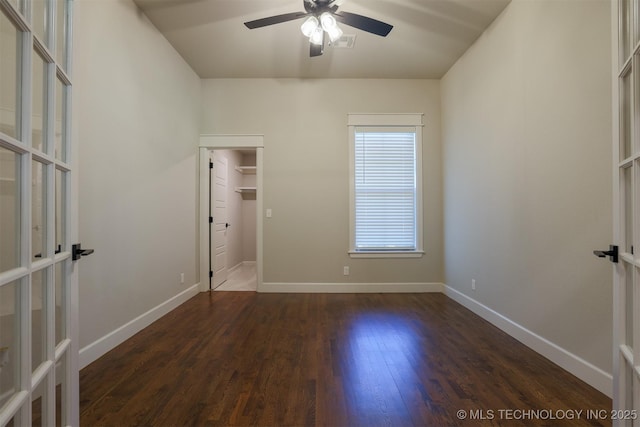 7141 E 138th Pl, Collinsville, OK 74021 - unfurnished bedroom featuring dark wood-style flooring, french doors, a walk in closet, and ceiling fan