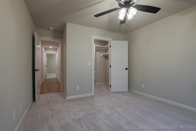7141 E 138th Pl, Collinsville, OK 74021 - unfurnished bedroom with light carpet, a walk in closet, and a ceiling fan