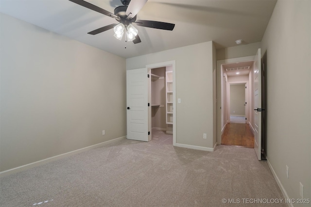 7141 E 138th Pl, Collinsville, OK 74021 - unfurnished bedroom featuring carpet flooring, a spacious closet, and ceiling fan