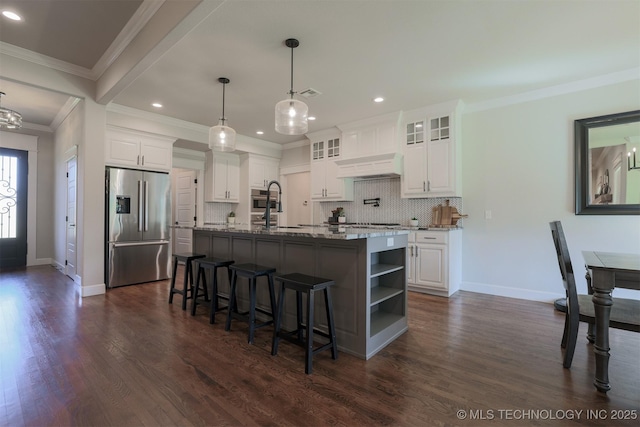 7141 E 138th Pl, Collinsville, OK 74021 - kitchen with stainless steel refrigerator with ice dispenser, decorative backsplash, premium range hood, white cabinetry, and dark wood-type flooring