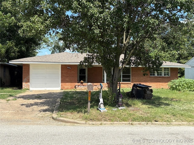 4800 E Frank Phillips Blvd, Bartlesville, OK 74006 - ranch-style home with brick siding, a garage, concrete driveway, and a front yard