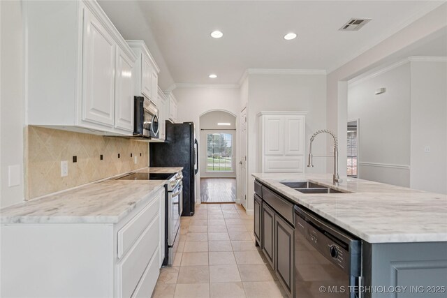 2629 S 13th St, Broken Arrow, OK 74012 - kitchen with appliances with stainless steel finishes, white cabinetry, decorative backsplash, recessed lighting, and light stone counters