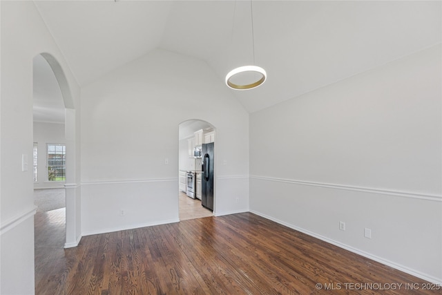 2629 S 13th St, Broken Arrow, OK 74012 - empty room featuring arched walkways, wood finished floors, and high vaulted ceiling