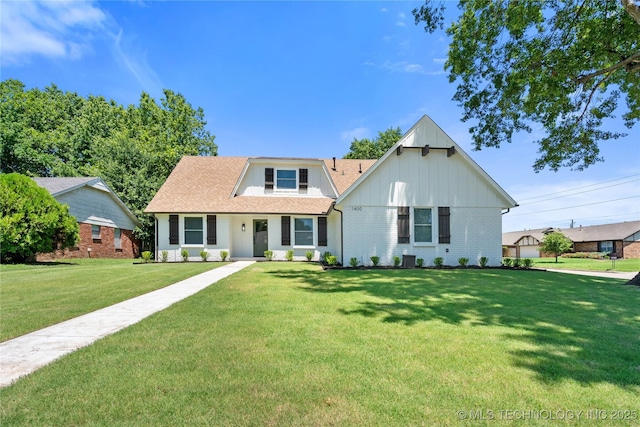 1400 W Jackson St, Broken Arrow, OK 74012 - view of front facade with board and batten siding, a front lawn, brick siding, and roof with shingles