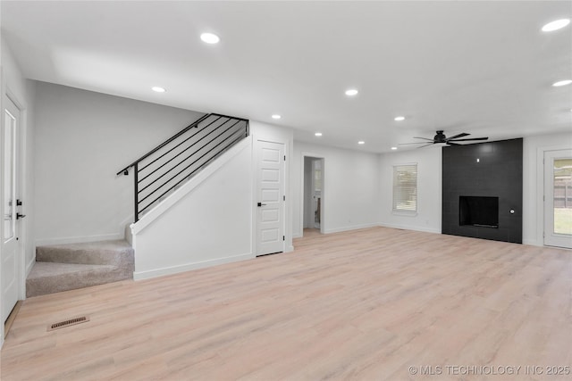 1400 W Jackson St, Broken Arrow, OK 74012 - unfurnished living room with a ceiling fan, recessed lighting, stairs, light wood-style flooring, and a fireplace
