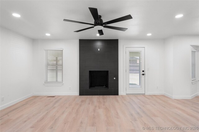 1400 W Jackson St, Broken Arrow, OK 74012 - unfurnished living room featuring a fireplace, recessed lighting, a ceiling fan, and wood finished floors
