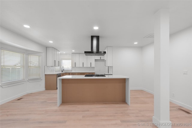 1400 W Jackson St, Broken Arrow, OK 74012 - kitchen featuring wall chimney range hood, light countertops, a center island, gas stovetop, and recessed lighting