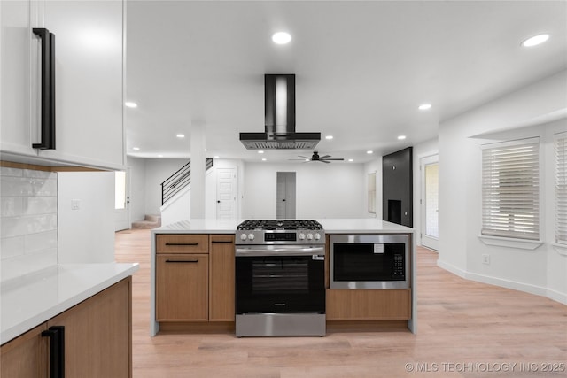 1400 W Jackson St, Broken Arrow, OK 74012 - kitchen featuring appliances with stainless steel finishes, wall chimney range hood, light wood-style floors, light countertops, and recessed lighting