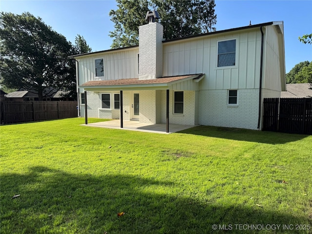 1400 W Jackson St, Broken Arrow, OK 74012 - back of house with board and batten siding, a patio, and a fenced backyard