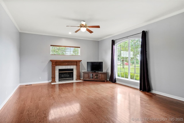 10672 E Canyon Oaks Ct, Claremore, OK 74017 - unfurnished living room with ceiling fan, wood finished floors, ornamental molding, a tile fireplace, and recessed lighting