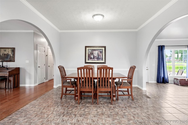10672 E Canyon Oaks Ct, Claremore, OK 74017 - dining area featuring ornamental molding, a textured ceiling, and arched walkways