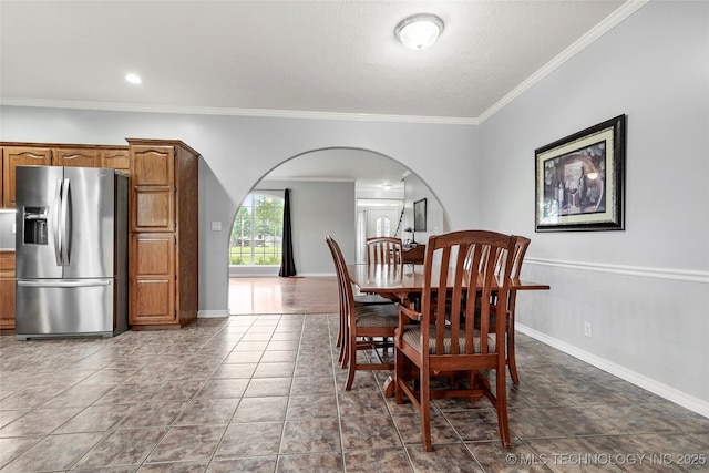 10672 E Canyon Oaks Ct, Claremore, OK 74017 - dining area with arched walkways, ornamental molding, and a textured ceiling