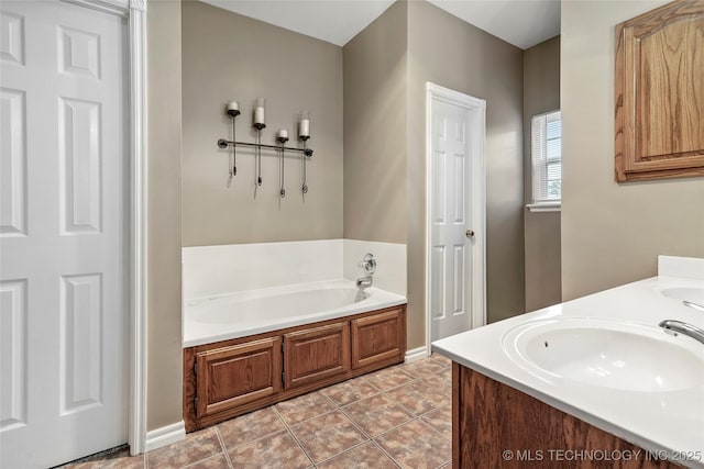 10672 E Canyon Oaks Ct, Claremore, OK 74017 - bathroom featuring a garden tub, double vanity, and tile patterned flooring