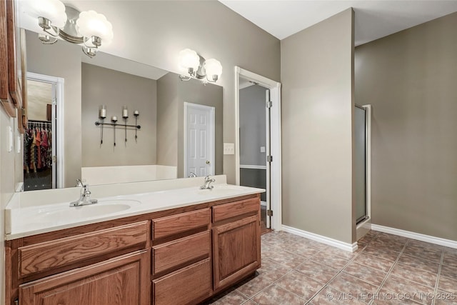 10672 E Canyon Oaks Ct, Claremore, OK 74017 - full bathroom with double vanity, a walk in closet, an enclosed shower, and tile patterned floors