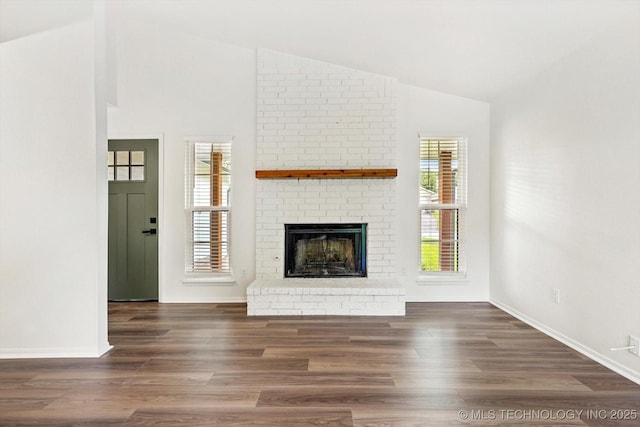 1847 W 57th Pl, Tulsa, OK 74107 - unfurnished living room featuring lofted ceiling, a fireplace, and wood finished floors