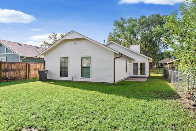 1847 W 57th Pl, Tulsa, OK 74107 - rear view of property featuring french doors, a chimney, and a fenced backyard
