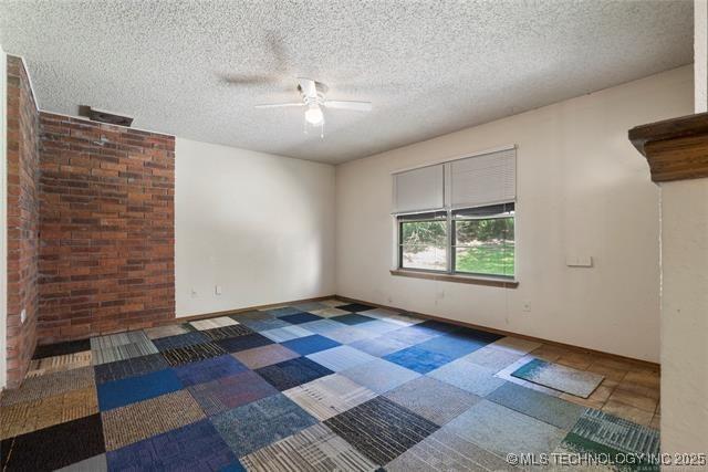 2608 Hickory Bluff Rd, Sapulpa, OK 74066 - empty room with ceiling fan and a textured ceiling