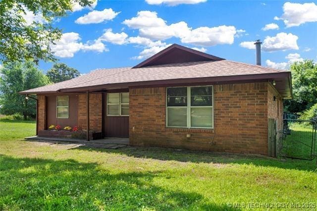 2608 Hickory Bluff Rd, Sapulpa, OK 74066 - rear view of house featuring a lawn, brick siding, and roof with shingles