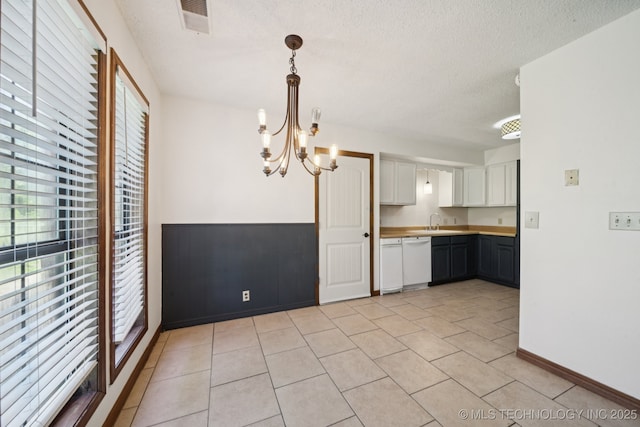 126 Birch Dr, Mannford, OK 74044 - kitchen featuring white dishwasher, white cabinetry, a chandelier, a textured ceiling, and light countertops