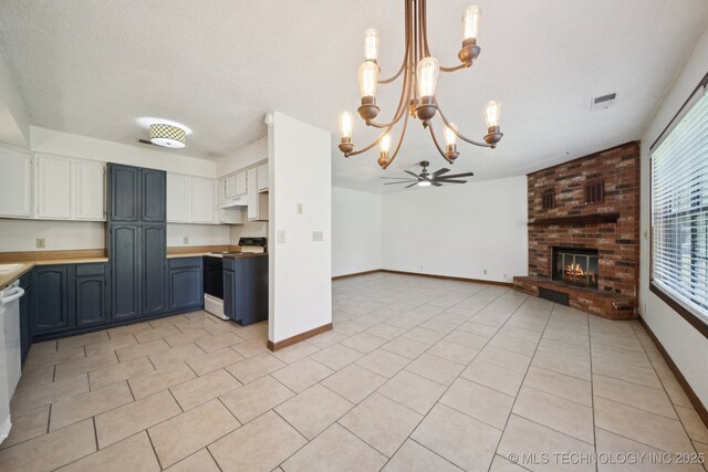 126 Birch Dr, Mannford, OK 74044 - kitchen with white electric stove, open floor plan, a chandelier, a fireplace, and light tile patterned flooring