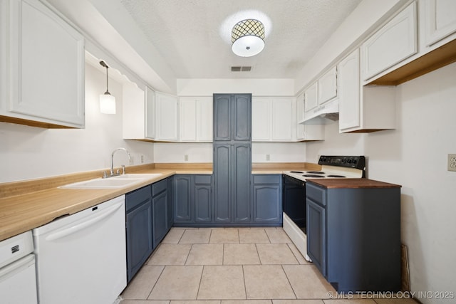 126 Birch Dr, Mannford, OK 74044 - kitchen with white appliances, blue cabinets, under cabinet range hood, white cabinetry, and butcher block countertops