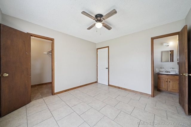 126 Birch Dr, Mannford, OK 74044 - unfurnished bedroom featuring light tile patterned floors, a textured ceiling, ceiling fan, and ensuite bath