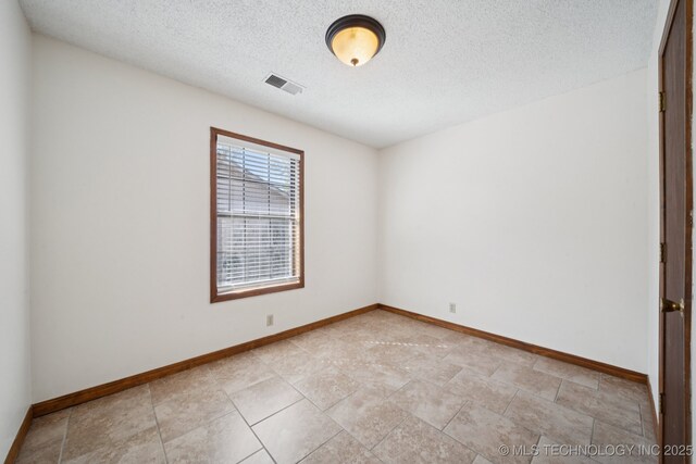 126 Birch Dr, Mannford, OK 74044 - spare room featuring a textured ceiling and baseboards