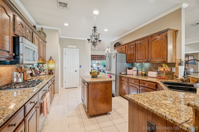 8702 N 140th Ter, Owasso, OK 74055 - kitchen with stainless steel appliances, a center island, tasteful backsplash, light stone countertops, and ornamental molding
