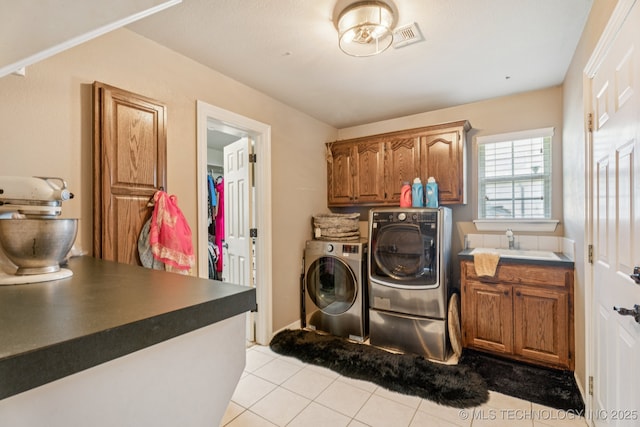 8702 N 140th Ter, Owasso, OK 74055 - laundry room featuring washing machine and clothes dryer, cabinet space, and light tile patterned flooring