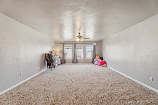 8702 N 140th Ter, Owasso, OK 74055 - playroom with a textured wall, carpet floors, and a ceiling fan
