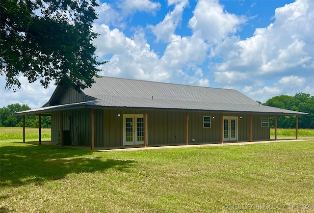 16547 County Road 1600, Ada, OK 74820 - back of property with french doors, board and batten siding, and a lawn