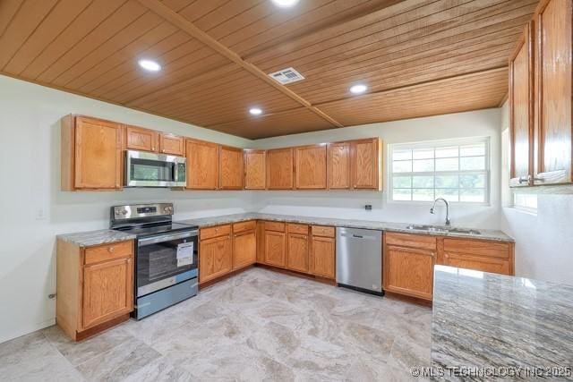 16547 County Road 1600, Ada, OK 74820 - kitchen featuring appliances with stainless steel finishes, wooden ceiling, recessed lighting, brown cabinetry, and light stone countertops