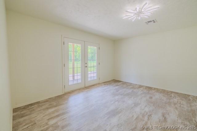 16547 County Road 1600, Ada, OK 74820 - unfurnished room featuring french doors and wood finished floors