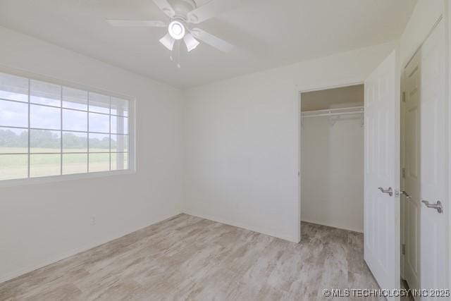 16547 County Road 1600, Ada, OK 74820 - unfurnished bedroom featuring a closet, light wood finished floors, and a ceiling fan