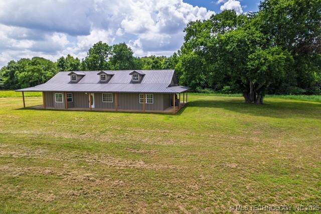 16547 County Road 1600, Ada, OK 74820 - view of front of home with a front yard, view of scattered trees, a carport, and a porch