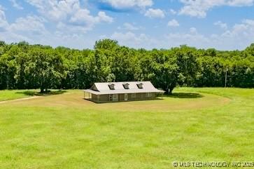 16547 County Road 1600, Ada, OK 74820 - view of front facade with a front lawn and a forest view